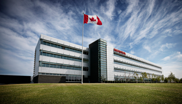 An exterior shot of a Honda factory in the sunshine. 